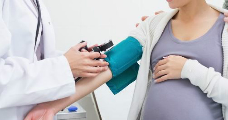 Pregnant Woman Takes Blood Pressure Test