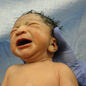 crying newborn baby doctors arms
