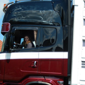 female truck driver behind wheel