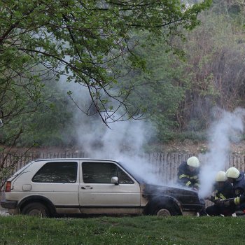 firefighters extinguishing car fire