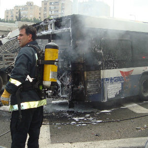 firemen at bus fire accident scene