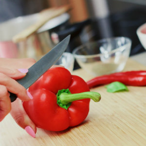 hand slicing red pepper