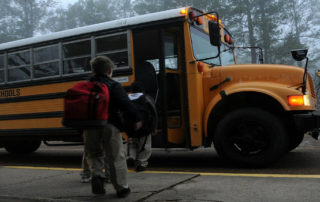 kids getting on school bus