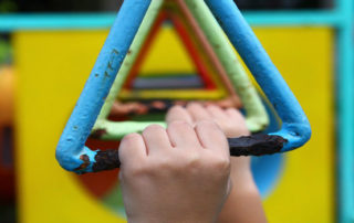 kids hands and jungle gym