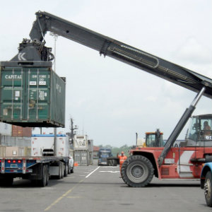 loading cargo container onto flatbed