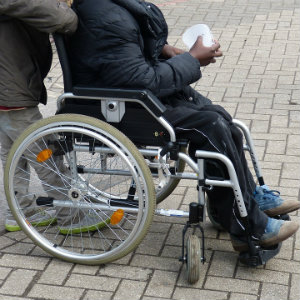 man being pushed in wheelchair