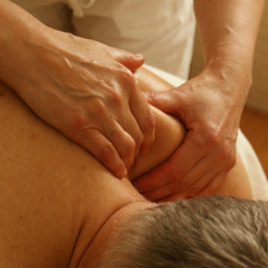 man getting shoulder massaged