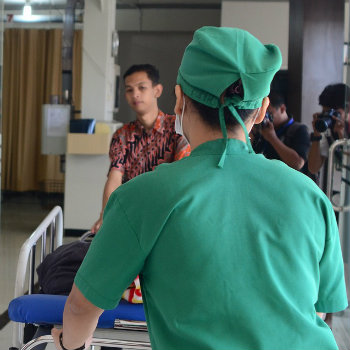 nurse and doctor moving patient