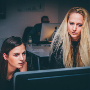 two women working at computer
