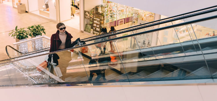 woman on shopping mall escalator