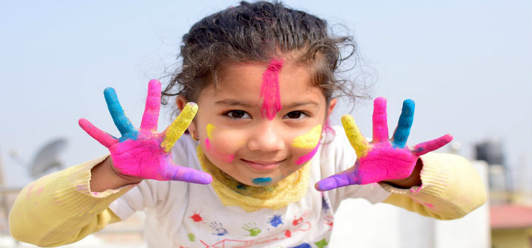 young girl with paint on hands